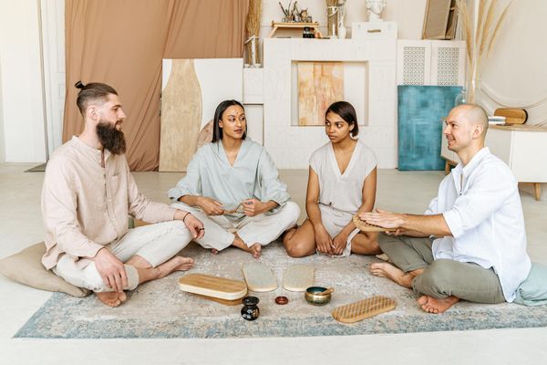 Diverse group smiling during a peaceful yoga session.
