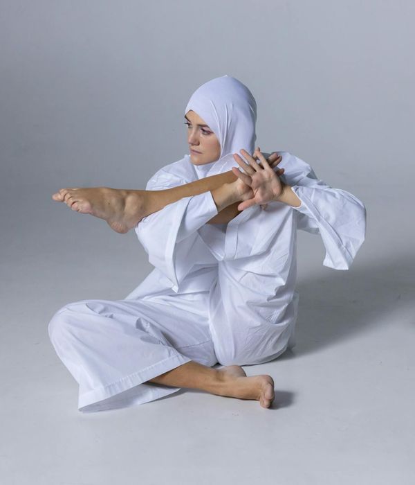 Woman in a graceful yoga pose, finding peace indoors.