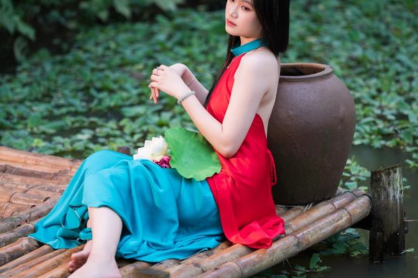 Woman meditating serenely in a vibrant, peaceful setting.